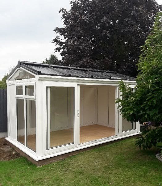 White clad garden room on a lawn